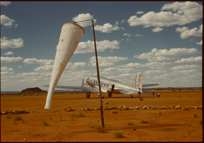 Windsock and MMA DC3 VH-MMM 'RMA Murchison' on the airstrip at Roy Hill Station.